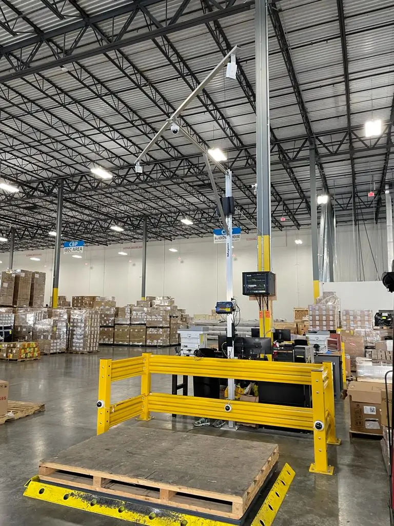 Automated freight dimensioning and weighing station inside Draco Freight Logistics’ warehouse, used for precise cargo measurement, data capture, and shipment optimization.