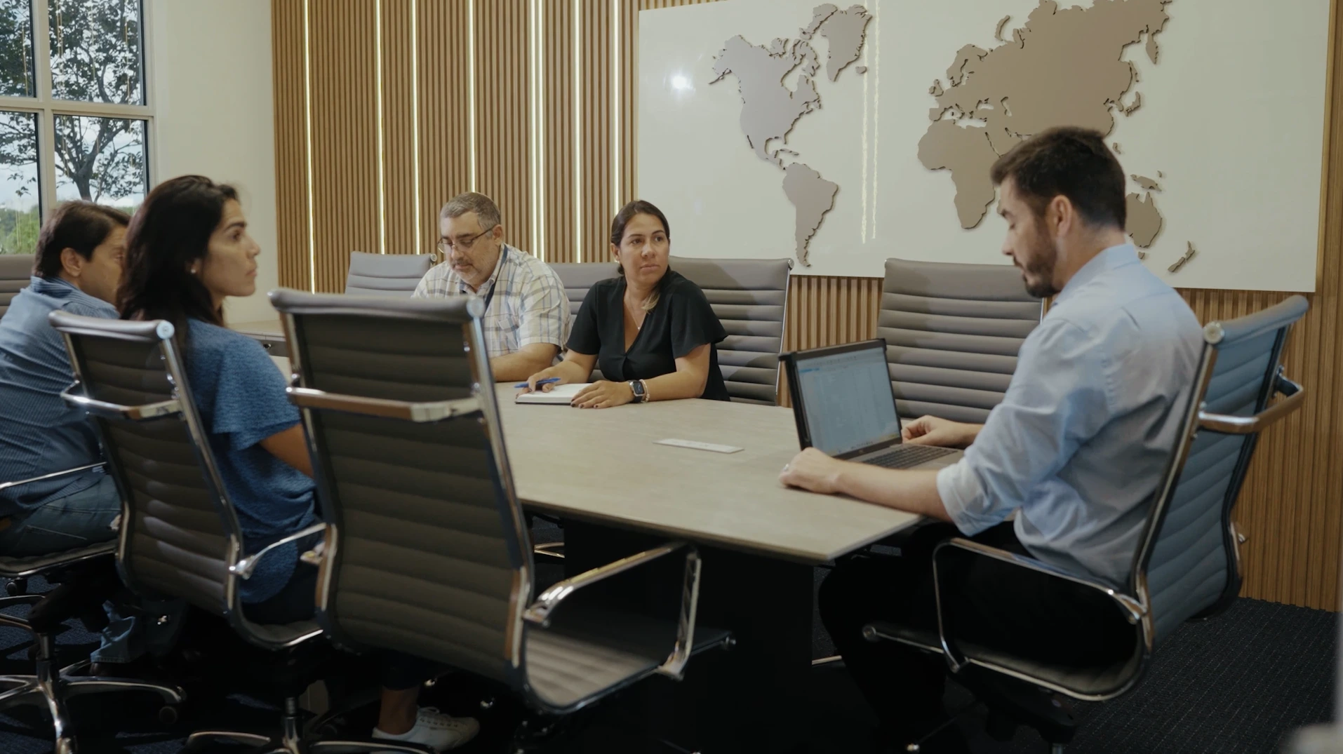 Draco Freight Logistics team gathered in a conference room discussing operations and supply chain strategies.