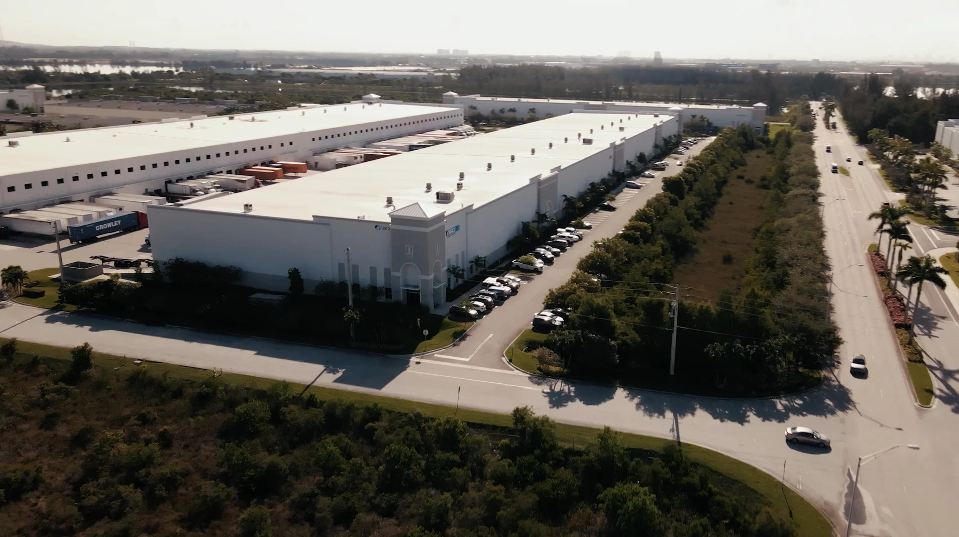 A wide aerial view of the Draco Freight Logistics headquarters and expansive warehouse complex, showcasing the scale of the facility and surrounding infrastructure.