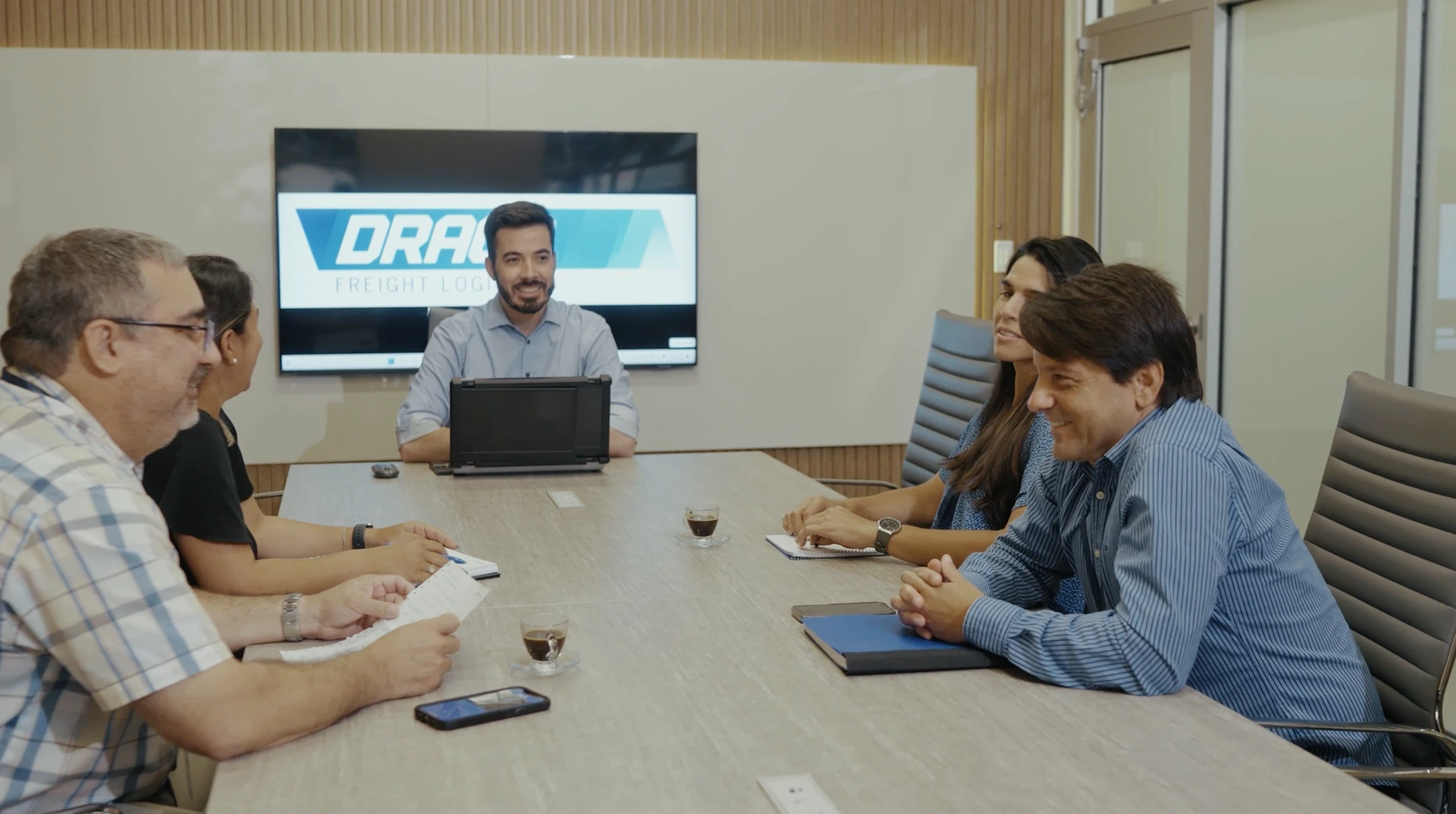 Draco Freight Logistics leadership team in a meeting discussing global freight and logistics solutions.